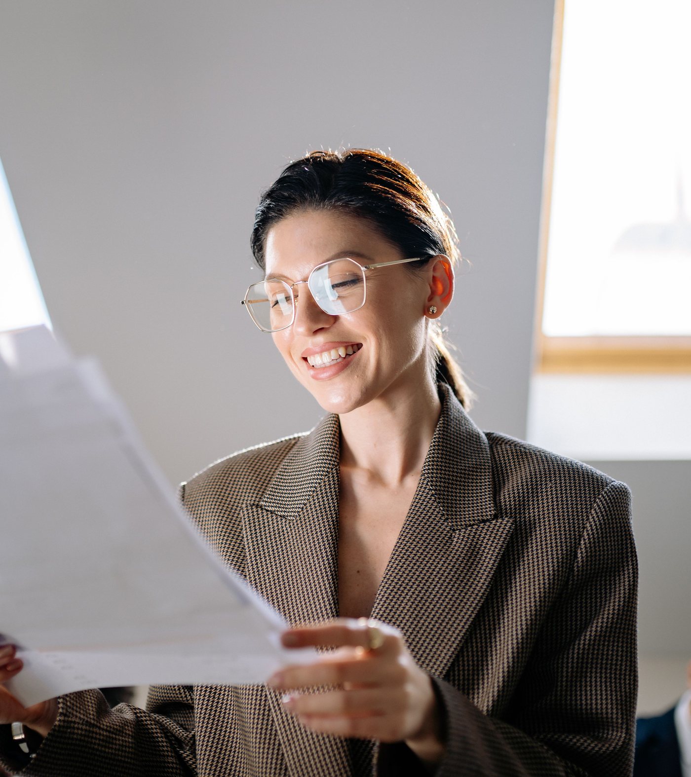 Woman smiling while reviewing a novated lease finance document with ONBOARD FINANCE PTY LTD